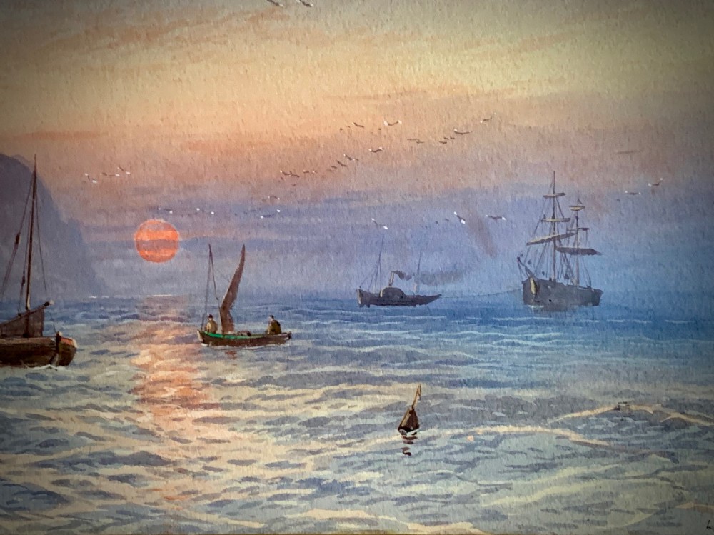A horizontal Victorian watercolour painting depicting sailing boats in a coastal harbour at sunset, set within a wide gilded frame. View V