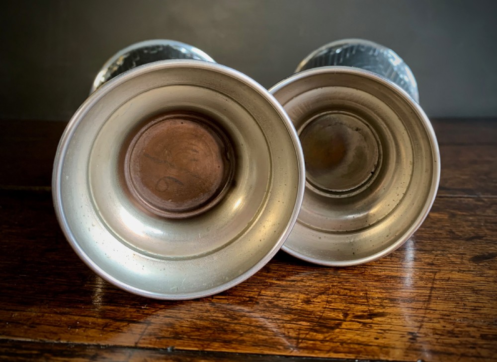 A pair of Art Deco chrome-plated metal vases with hammered lower bodies, geometric moulding near the rim, and circular stepped bases. View VI