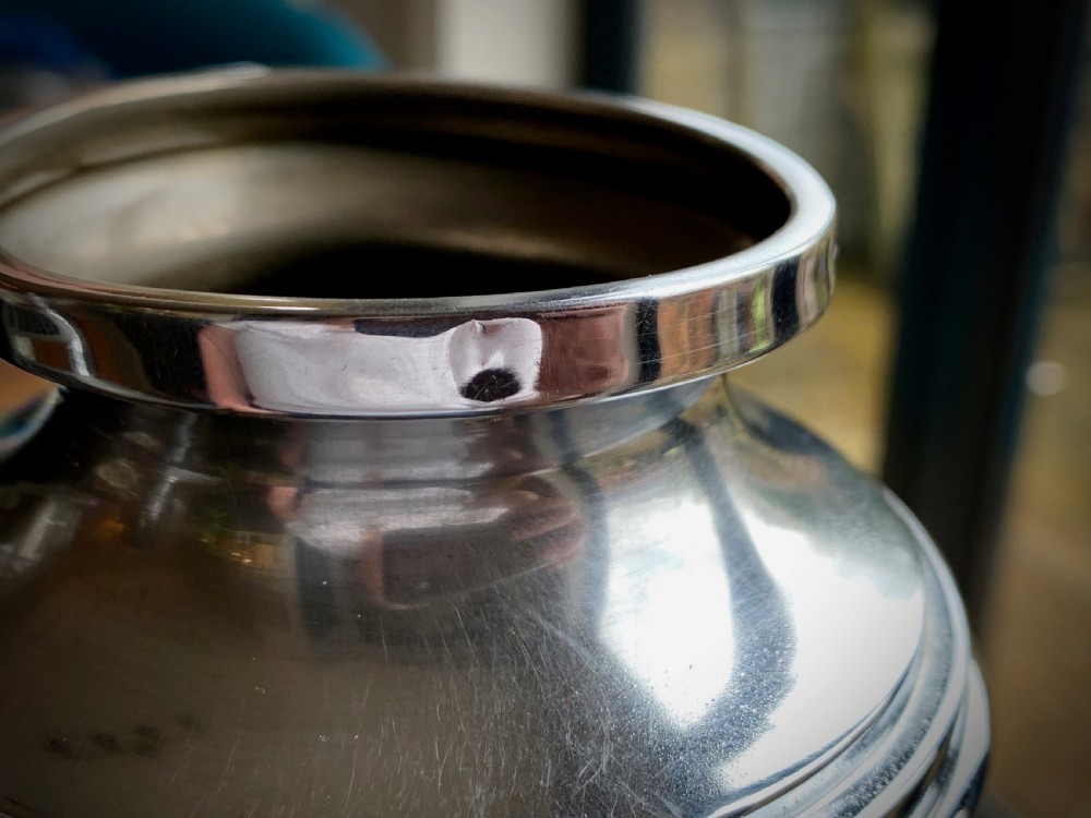 A pair of Art Deco chrome-plated metal vases with hammered lower bodies, geometric moulding near the rim, and circular stepped bases. View VIII