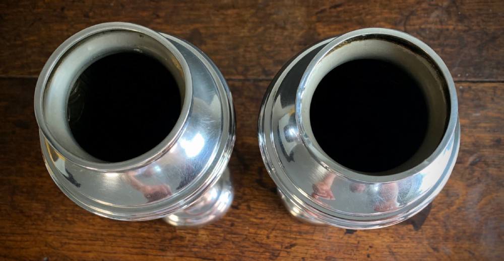 A pair of Art Deco chrome-plated metal vases with hammered lower bodies, geometric moulding near the rim, and circular stepped bases. View IX