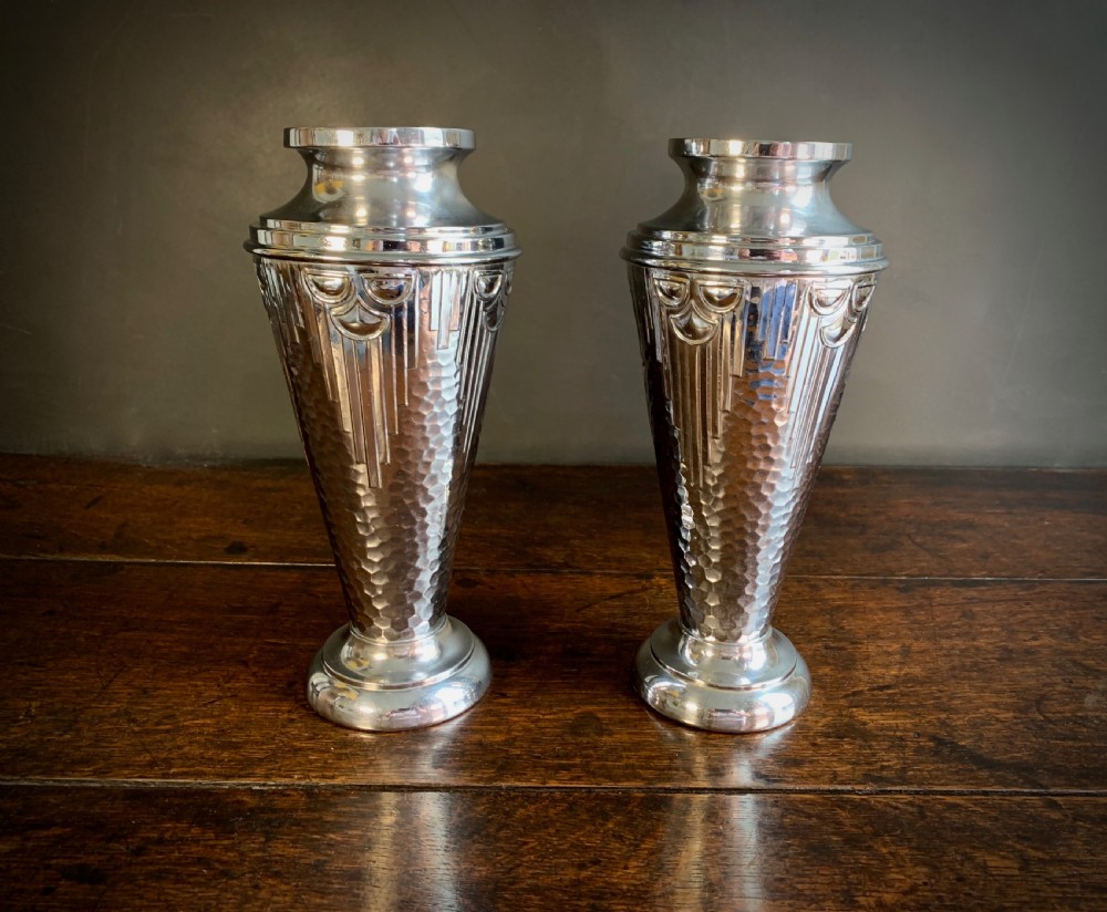 A pair of Art Deco chrome-plated metal vases with hammered lower bodies, geometric moulding near the rim, and circular stepped bases. View XI