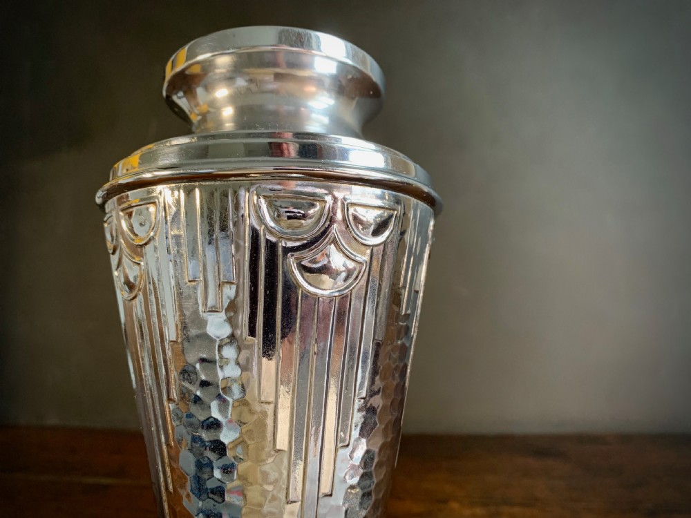 A pair of Art Deco chrome-plated metal vases with hammered lower bodies, geometric moulding near the rim, and circular stepped bases. View XII