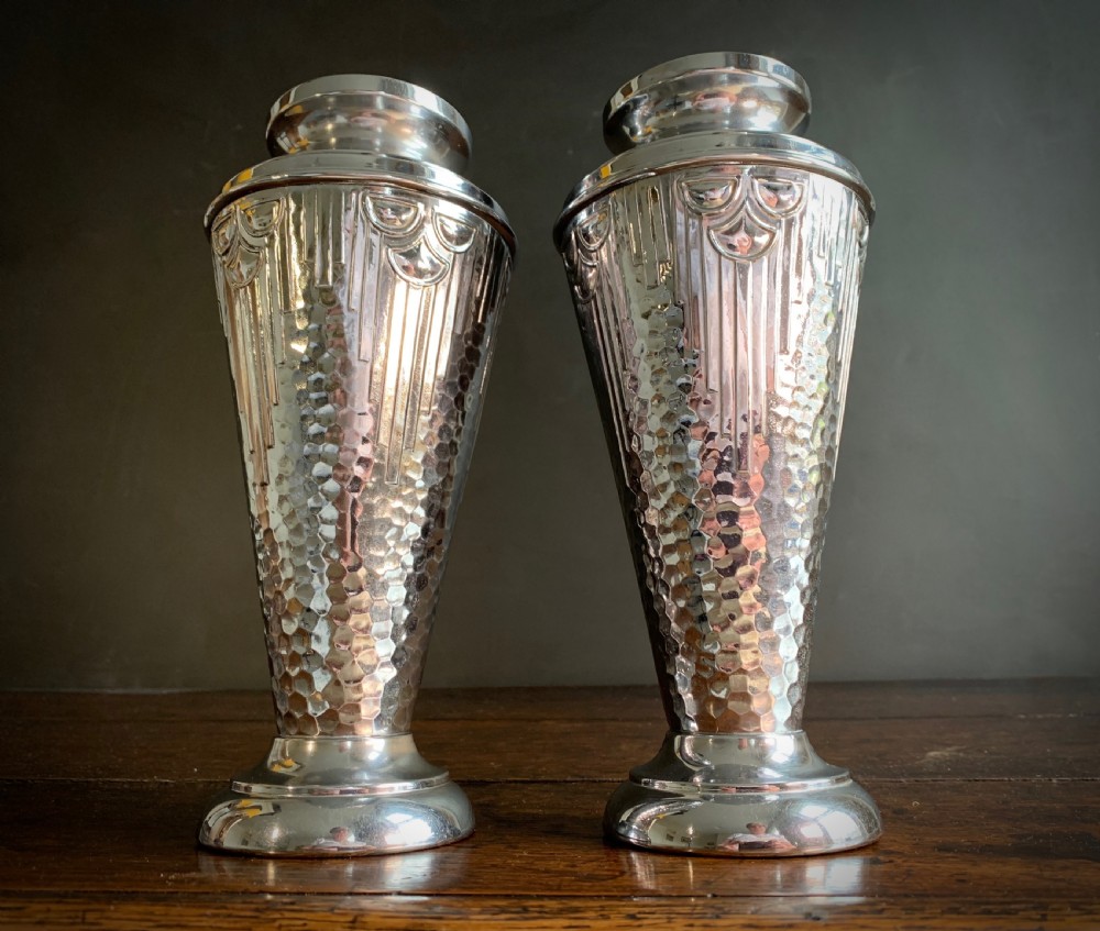 A pair of Art Deco chrome-plated metal vases with hammered lower bodies, geometric moulding near the rim, and circular stepped bases. View XIV