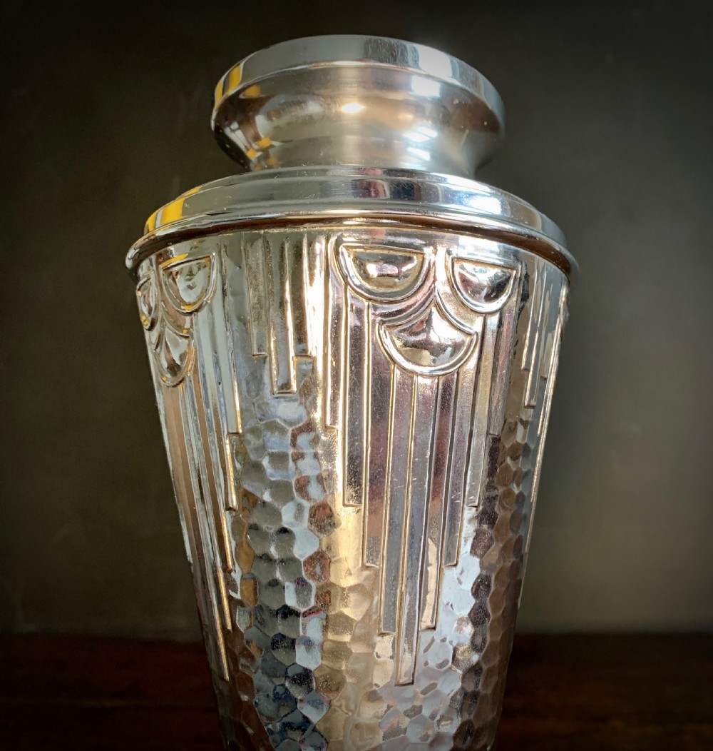 A pair of Art Deco chrome-plated metal vases with hammered lower bodies, geometric moulding near the rim, and circular stepped bases. View XV