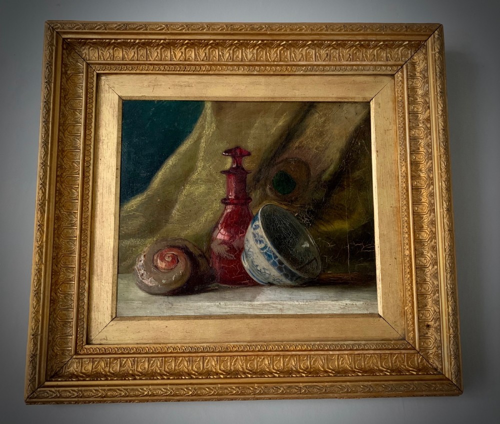 A 19th-century framed oil painting depicting a seashell, a red glass bottle, and a porcelain bowl set against draped fabric. View II