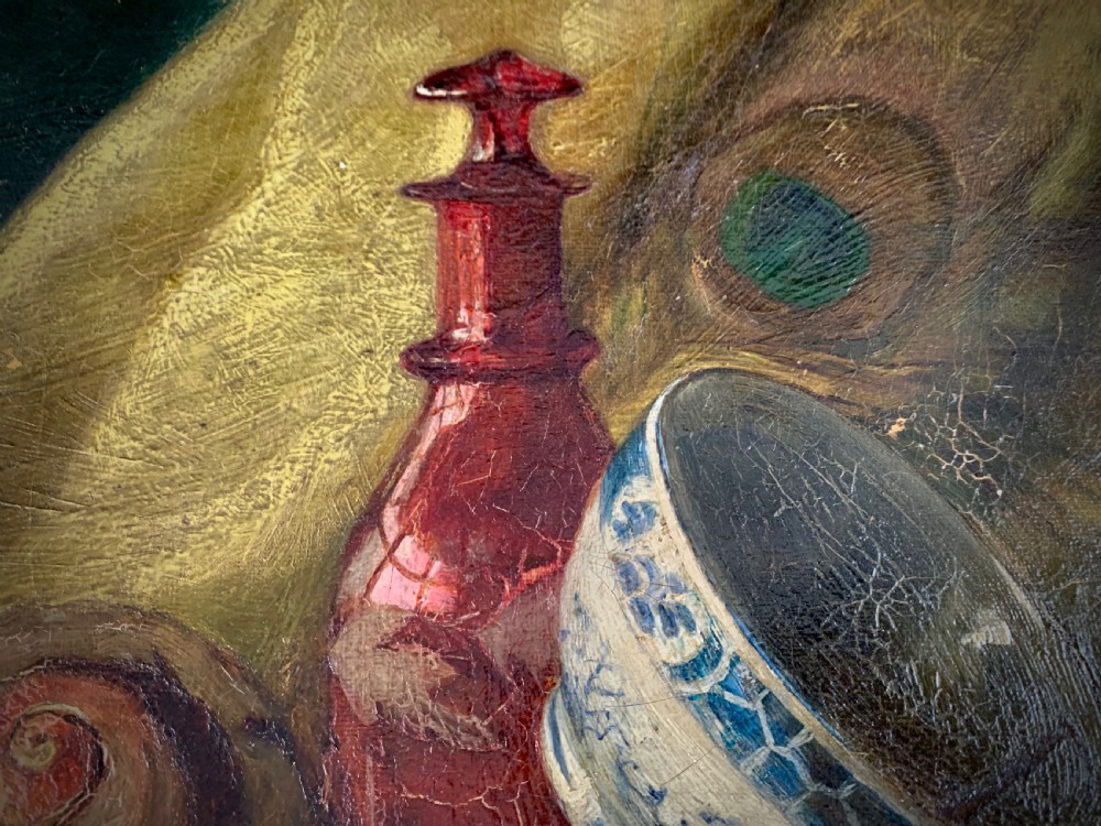 A 19th-century framed oil painting depicting a seashell, a red glass bottle, and a porcelain bowl set against draped fabric. View IV