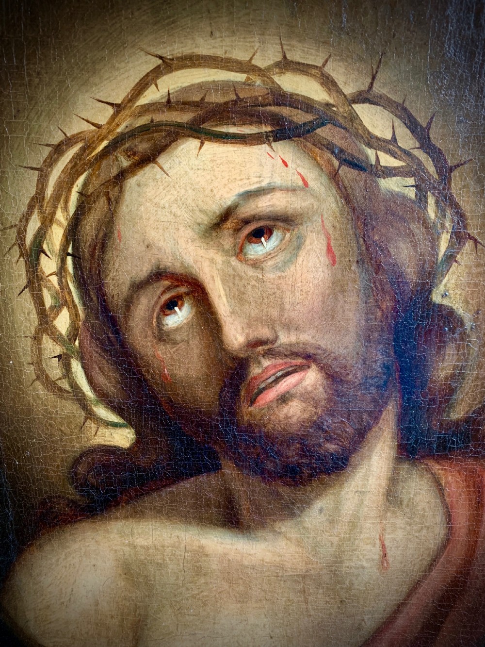 A 19th-century oil painting on canvas depicting Christ crowned with thorns set within a gold gilded wooden frame. View II