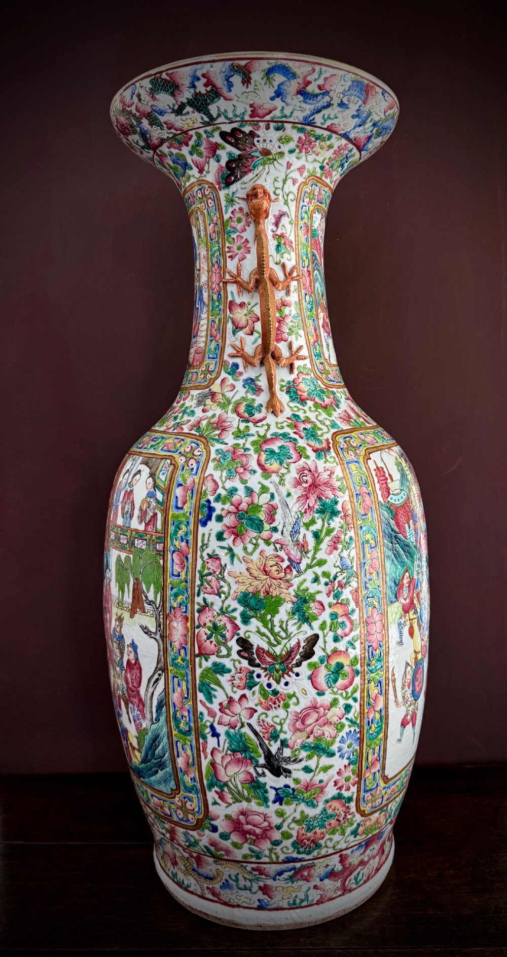 A large 19th-century Cantonese porcelain floor vase decorated with polychrome enamel court scenes, floral borders, and gilded dragon handles. View V