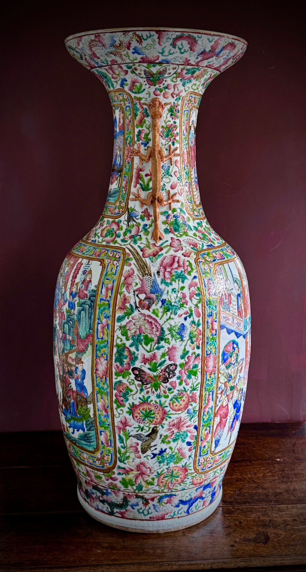 A large 19th-century Cantonese porcelain floor vase decorated with polychrome enamel court scenes, floral borders, and gilded dragon handles. View XIX