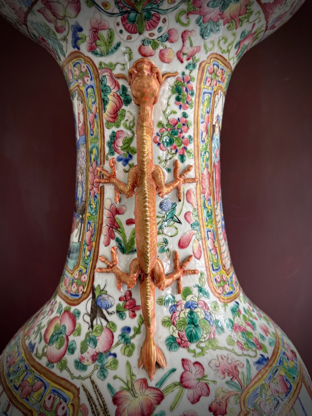 A large 19th-century Cantonese porcelain floor vase decorated with polychrome enamel court scenes, floral borders, and gilded dragon handles. View XX