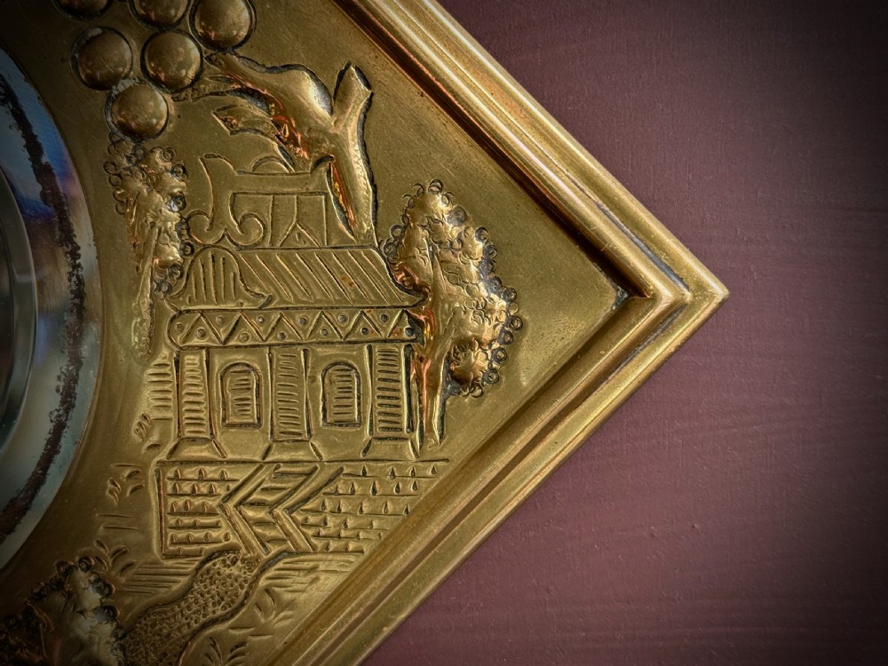 A pair of diamond-shaped embossed brass girandole wall mirrors featuring Chinoiserie scenes and twin candle branches. View IX