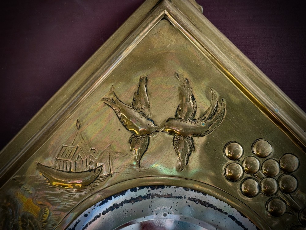 A pair of diamond-shaped embossed brass girandole wall mirrors featuring Chinoiserie scenes and twin candle branches. View X