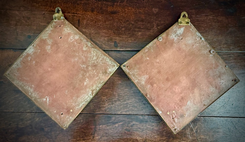 A pair of diamond-shaped embossed brass girandole wall mirrors featuring Chinoiserie scenes and twin candle branches. View XVI