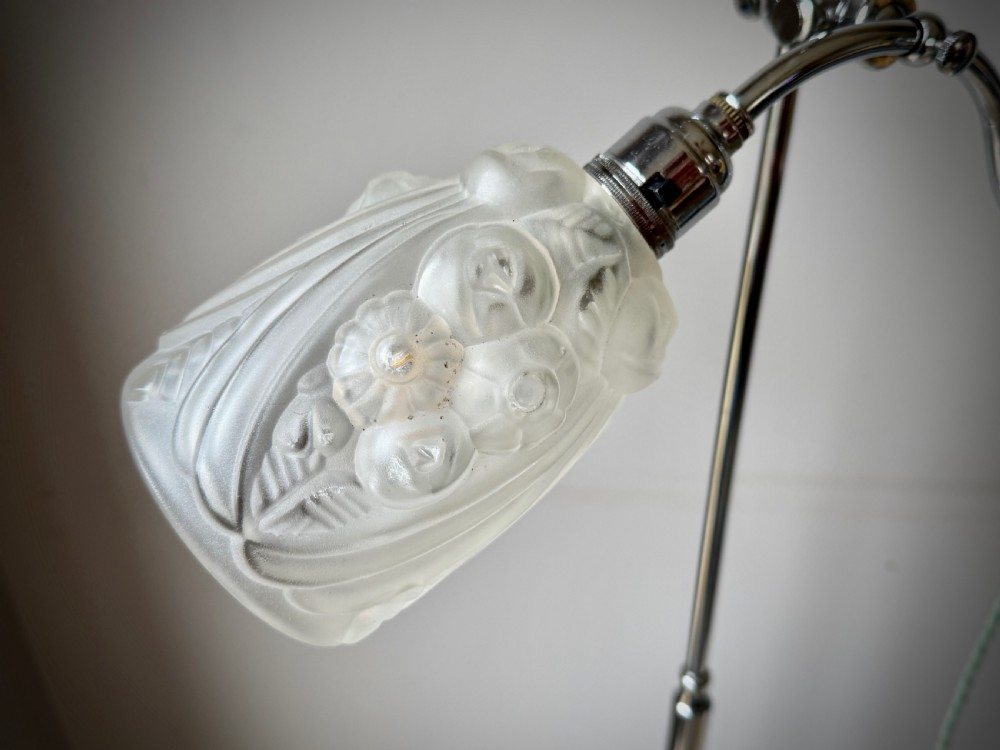 A slender 1920s Art Deco adjustable floor lamp crafted from polished chrome with an articulated neck and a lit frosted glass shade. View VI