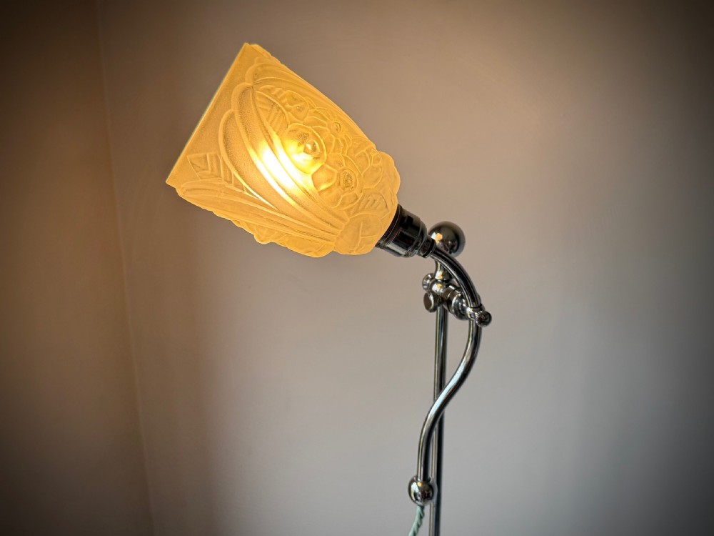 A slender 1920s Art Deco adjustable floor lamp crafted from polished chrome with an articulated neck and a lit frosted glass shade. View IX