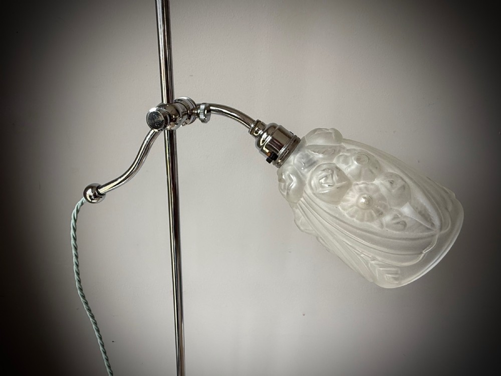 A slender 1920s Art Deco adjustable floor lamp crafted from polished chrome with an articulated neck and a lit frosted glass shade. View XII