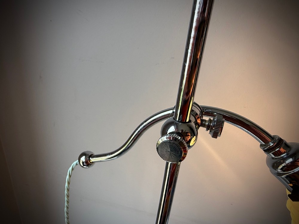 A slender 1920s Art Deco adjustable floor lamp crafted from polished chrome with an articulated neck and a lit frosted glass shade. View XIX