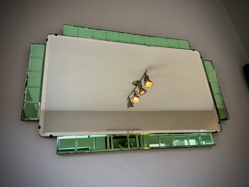 A rectangular Art Deco wall mirror featuring a central bevelled glass plate flanked by stepped emerald green tiled glass borders. View II