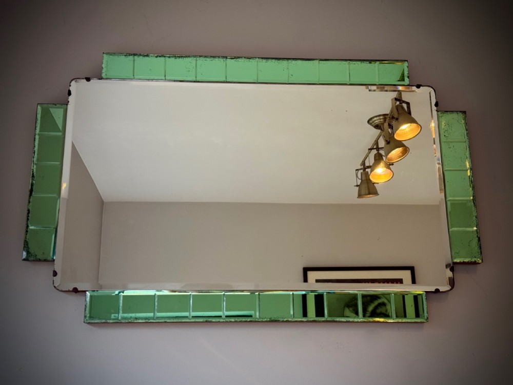 A rectangular Art Deco wall mirror featuring a central bevelled glass plate flanked by stepped emerald green tiled glass borders. View III