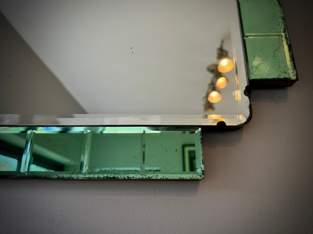 A rectangular Art Deco wall mirror featuring a central bevelled glass plate flanked by stepped emerald green tiled glass borders. View V