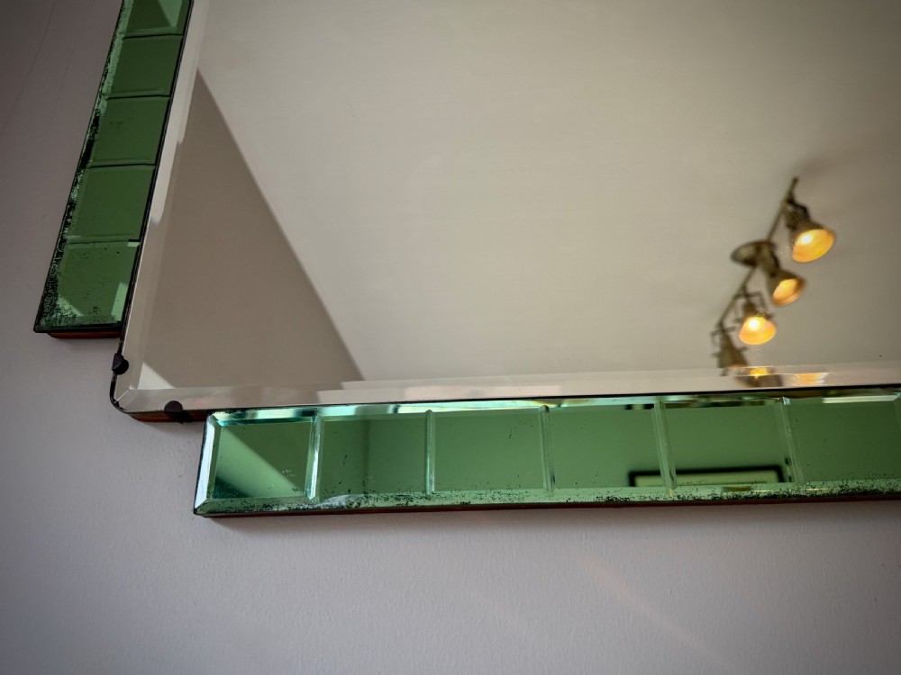 A rectangular Art Deco wall mirror featuring a central bevelled glass plate flanked by stepped emerald green tiled glass borders. View VII