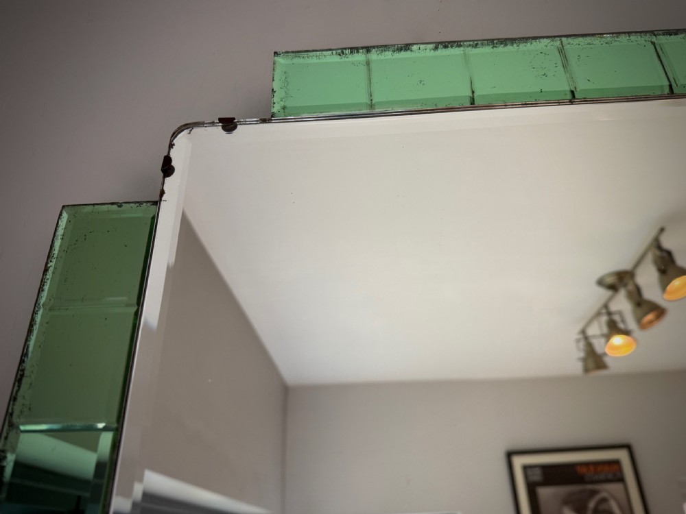 A rectangular Art Deco wall mirror featuring a central bevelled glass plate flanked by stepped emerald green tiled glass borders. View VIII