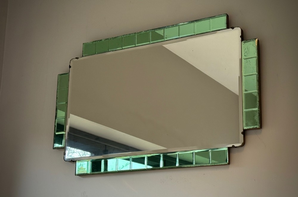 A rectangular Art Deco wall mirror featuring a central bevelled glass plate flanked by stepped emerald green tiled glass borders. View XI