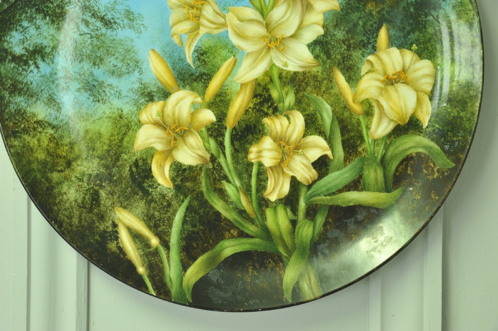 A circular hand-painted porcelain decorative plate displaying yellow lilies against foliage and a blue sky. View III