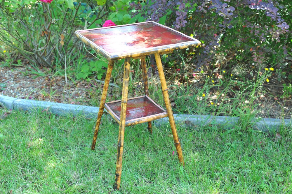 A two-tier bamboo side table featuring a square red lacquered top and lower shelf decorated with gilded bird and botanical motifs. View IV