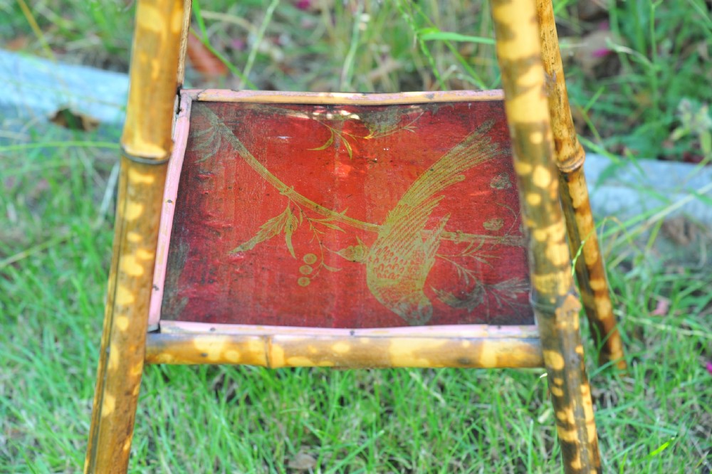 A two-tier bamboo side table featuring a square red lacquered top and lower shelf decorated with gilded bird and botanical motifs. View VI