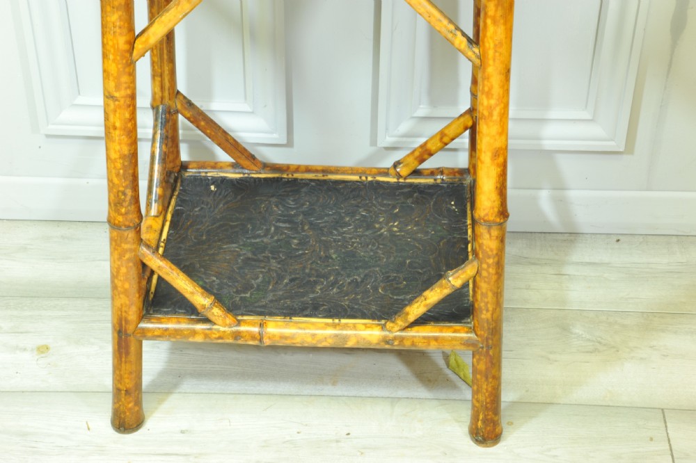 A late Victorian two-tier bamboo side table featuring a dark lacquered top panel decorated with botanical flora and birds. View III