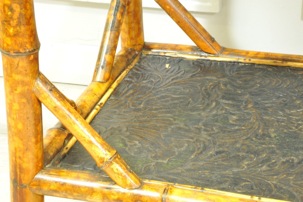 A late Victorian two-tier bamboo side table featuring a dark lacquered top panel decorated with botanical flora and birds. View XIII