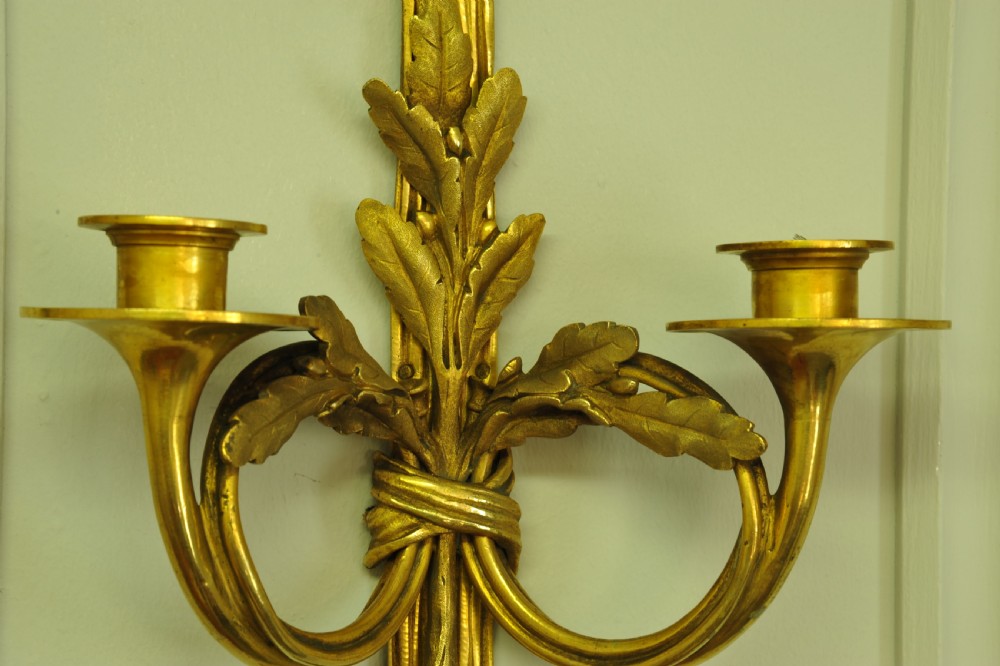 A pair of nineteenth-century French gilt bronze wall sconces featuring ribbon bow tops, tassel drops, and two curved candle branches. View XII