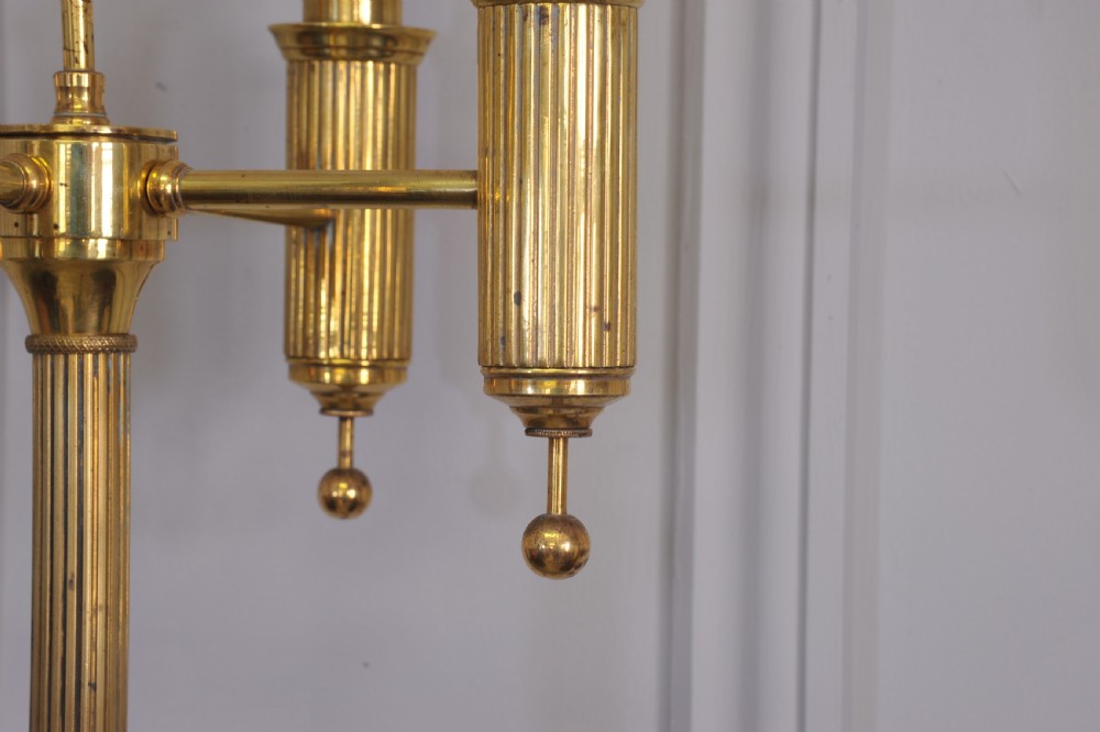 A brass French bouillotte style standard lamp featuring four fluted candle sockets with tulip glass shades and a central ring finial. View IV