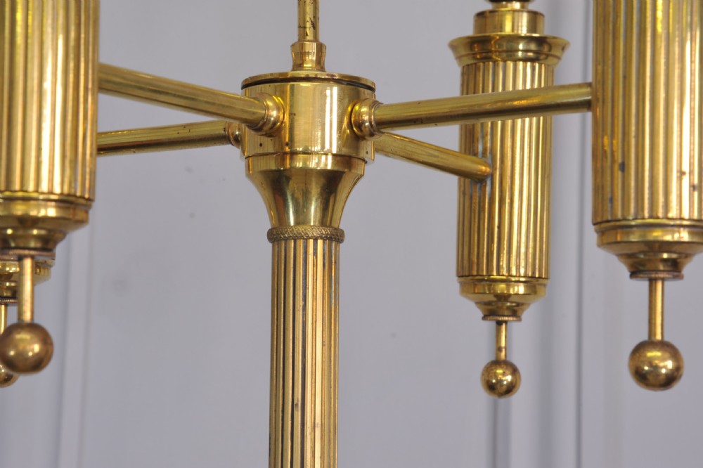 A brass French bouillotte style standard lamp featuring four fluted candle sockets with tulip glass shades and a central ring finial. View IX