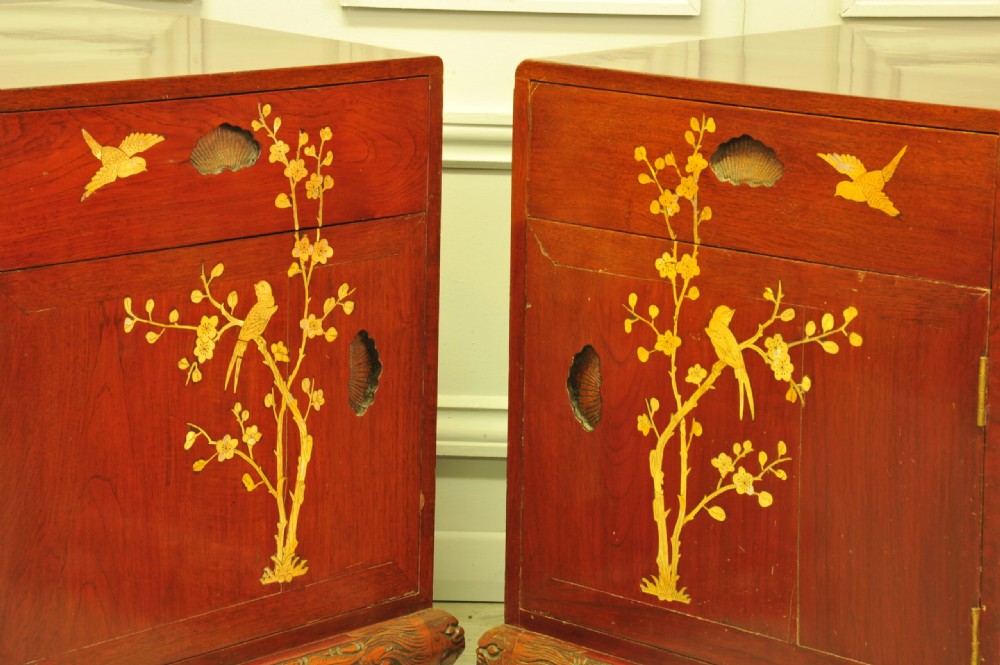 A pair of reddish-brown wood side cabinets featuring hand-painted gilt Chinoiserie floral and bird motifs resting on carved plinths. View III