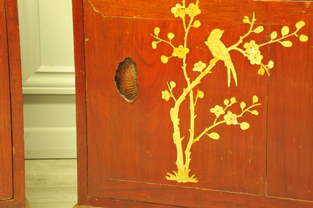 A pair of reddish-brown wood side cabinets featuring hand-painted gilt Chinoiserie floral and bird motifs resting on carved plinths. View VII
