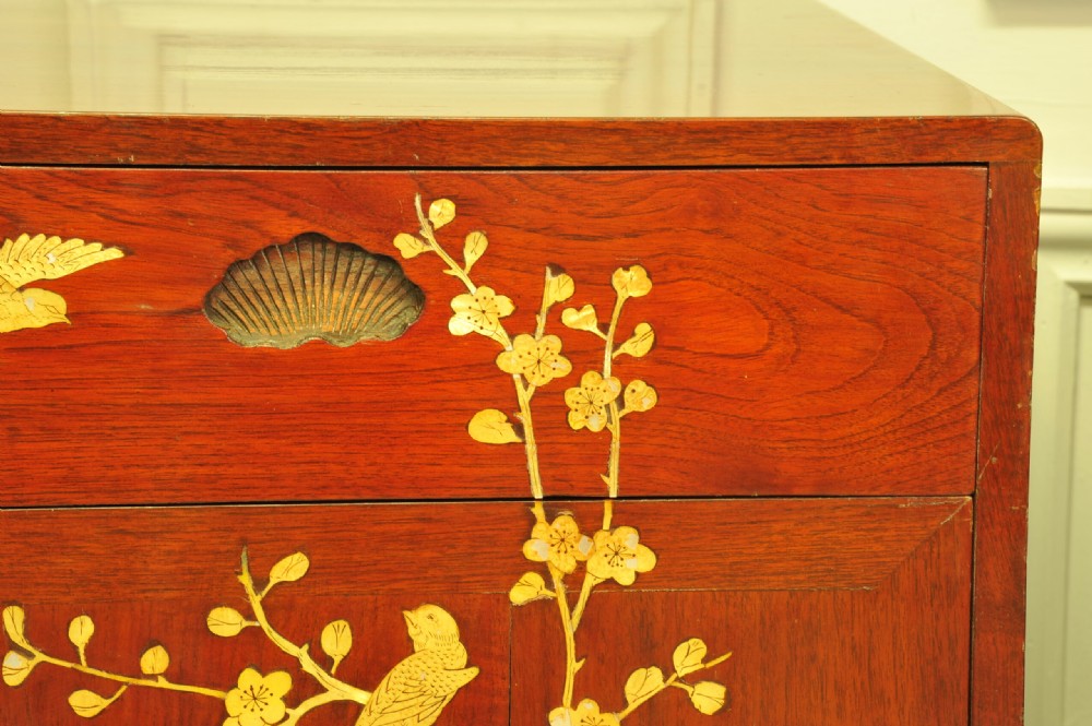 A pair of reddish-brown wood side cabinets featuring hand-painted gilt Chinoiserie floral and bird motifs resting on carved plinths. View VIII