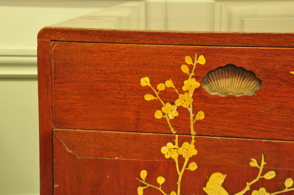 A pair of reddish-brown wood side cabinets featuring hand-painted gilt Chinoiserie floral and bird motifs resting on carved plinths. View IX