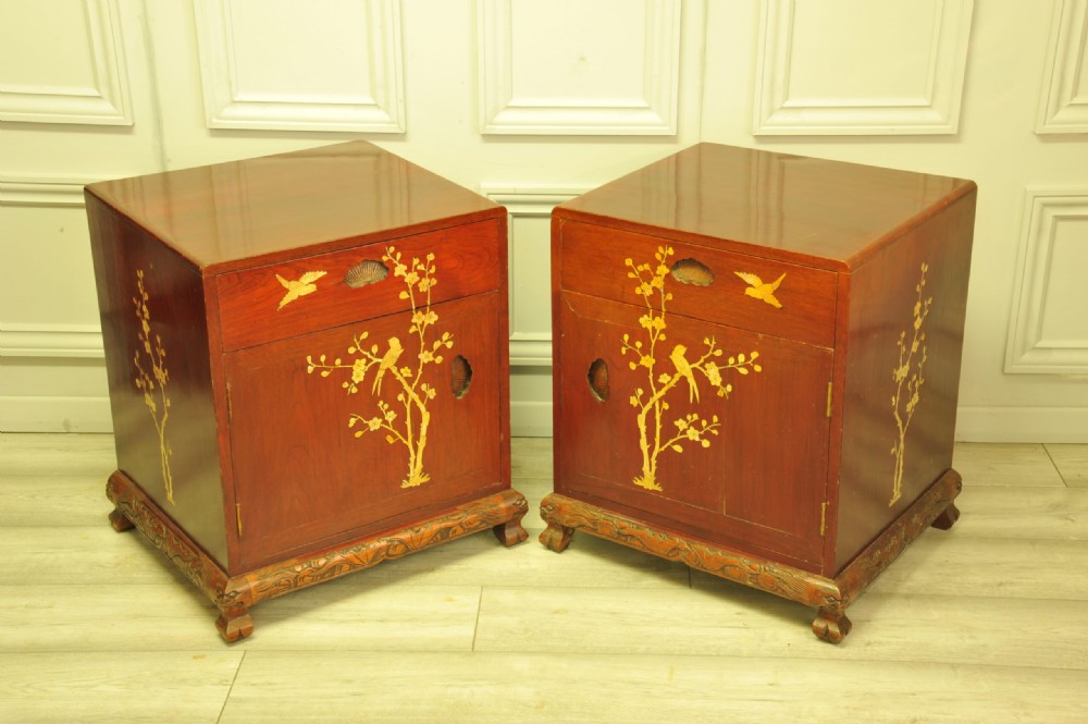 A pair of reddish-brown wood side cabinets featuring hand-painted gilt Chinoiserie floral and bird motifs resting on carved plinths. View XI