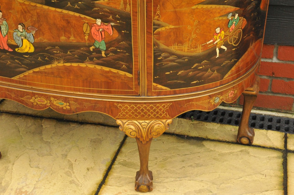 A circa 1910 semi-circular demi-lune cabinet featuring hand-painted Chinoiserie figures and landscapes with gilt details on cabriole legs. View XI