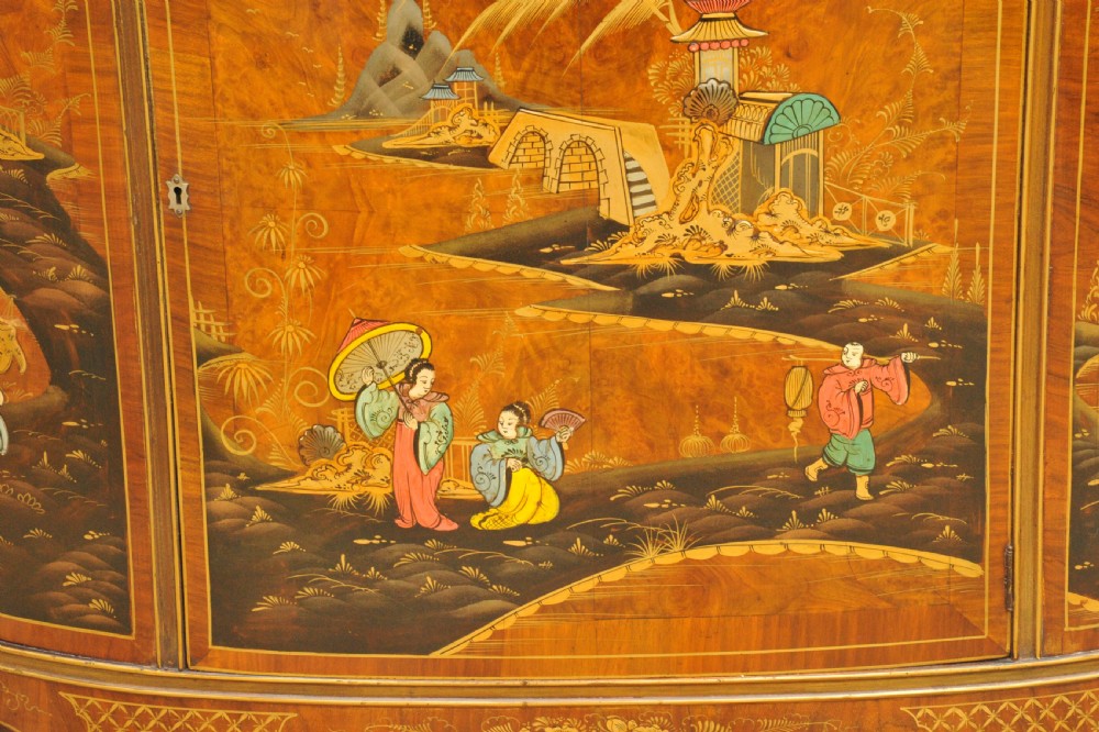 A circa 1910 semi-circular demi-lune cabinet featuring hand-painted Chinoiserie figures and landscapes with gilt details on cabriole legs. View XXII