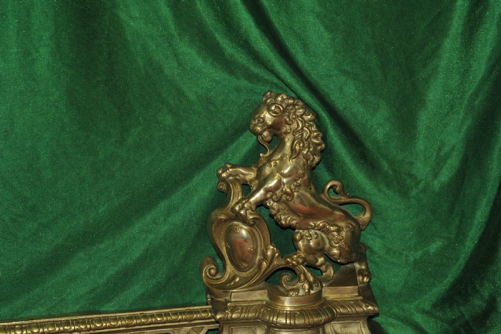 A cast brass Louis XV style fireplace fender featuring a central pierced lattice gallery flanked by two sculpted lions resting on shields. View VIII