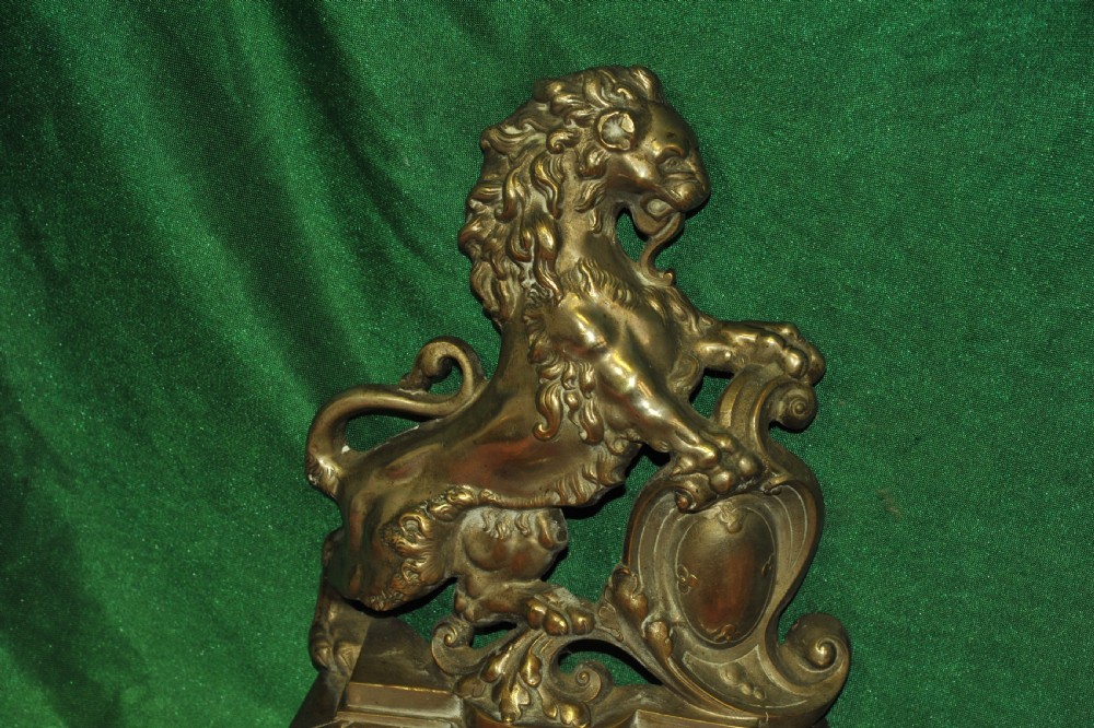 A cast brass Louis XV style fireplace fender featuring a central pierced lattice gallery flanked by two sculpted lions resting on shields. View XI