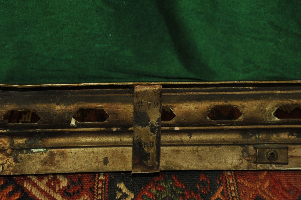 A cast brass Louis XV style fireplace fender featuring a central pierced lattice gallery flanked by two sculpted lions resting on shields. View XV