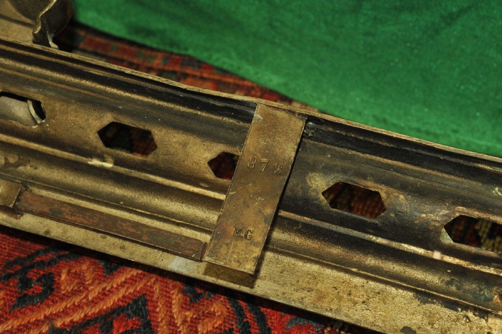 A cast brass Louis XV style fireplace fender featuring a central pierced lattice gallery flanked by two sculpted lions resting on shields. View XVII
