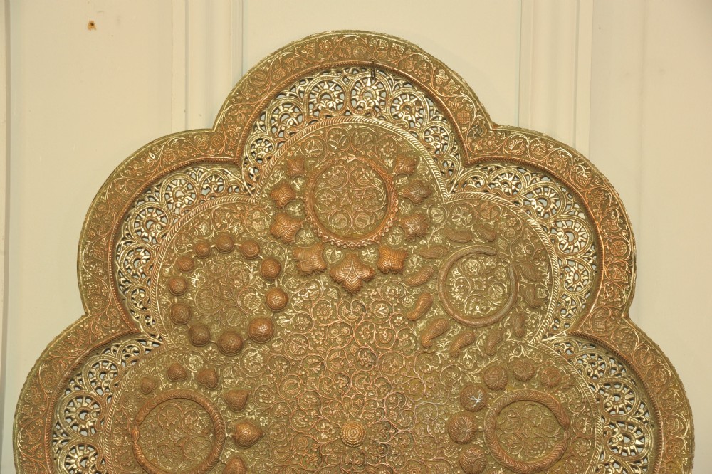 An antique Kashmiri lobed copper tray featuring detailed repousse floral work, pierced openwork sections, and residual silver plating. View II