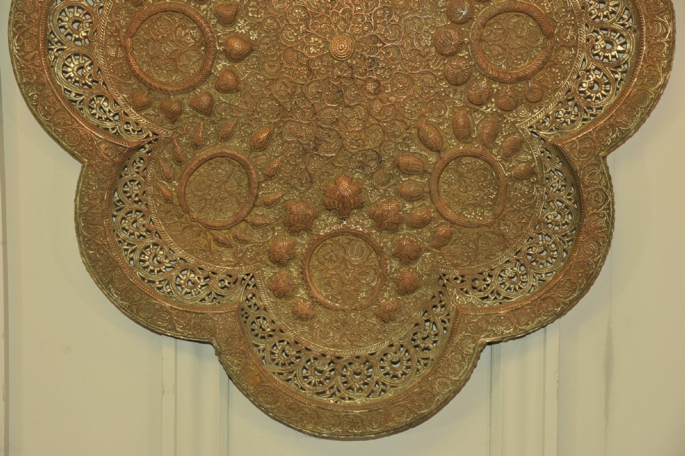 An antique Kashmiri lobed copper tray featuring detailed repousse floral work, pierced openwork sections, and residual silver plating. View III