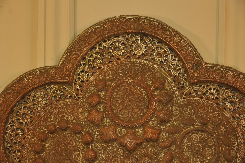 An antique Kashmiri lobed copper tray featuring detailed repousse floral work, pierced openwork sections, and residual silver plating. View IV