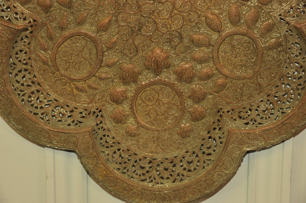 An antique Kashmiri lobed copper tray featuring detailed repousse floral work, pierced openwork sections, and residual silver plating. View VI